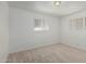 This bedroom features neutral carpet, and two large windows with blinds at 5625 E Dodge St, Mesa, AZ 85205