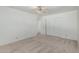 This bedroom features neutral carpet, a ceiling fan, and a double door closet at 5625 E Dodge St, Mesa, AZ 85205