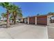 Exterior of house featuring a large driveway leading to a two-car garage and desert landscaping at 5625 E Dodge St, Mesa, AZ 85205