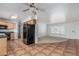 Open kitchen featuring tile floors, wood cabinets, black appliances, and access to the living room at 5625 E Dodge St, Mesa, AZ 85205