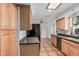 Traditional eat-in kitchen features wood cabinets, black appliances, tile floors and a bright skylight at 5625 E Dodge St, Mesa, AZ 85205
