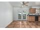Bright kitchen with tile flooring, wood cabinets, black countertops, and double glass doors at 5625 E Dodge St, Mesa, AZ 85205