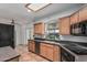 Modern kitchen features tile floor, wood cabinets, dark countertops, and stainless-steel dishwasher at 5625 E Dodge St, Mesa, AZ 85205