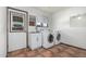 This laundry room features white appliances, a utility sink, and tile floors at 5625 E Dodge St, Mesa, AZ 85205