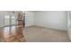 Bright living area with tile and carpet flooring, ceiling fan, and a view of the adjacent kitchen at 5625 E Dodge St, Mesa, AZ 85205