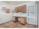 This home office features wood cabinets, a desk and tile floors at 5625 E Dodge St, Mesa, AZ 85205