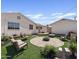 Beautiful backyard with a circular brick patio, seating area, lush grass, and manicured landscaping at 5738 N 34Th S Dr, Phoenix, AZ 85017
