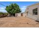 Spacious backyard featuring a lush tree, storage shed, and lots of potential for landscaping at 5738 N 34Th S Dr, Phoenix, AZ 85017