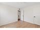 Bright bedroom featuring wood-look floors, fresh paint, a ceiling fan, and closet leading to a bathroom at 5738 N 34Th S Dr, Phoenix, AZ 85017