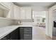 Bright kitchen with white cabinetry and stone countertops at 5738 N 34Th S Dr, Phoenix, AZ 85017