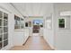 Bright sun room featuring multiple windows and doors, tile flooring, and built-in storage and countertop at 5738 N 34Th S Dr, Phoenix, AZ 85017