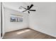 Bedroom with a ceiling fan, a large window and hardwood floors at 6108 S Wilson Dr, Chandler, AZ 85249