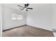 Bedroom with a ceiling fan, a large window and hardwood floors at 6108 S Wilson Dr, Chandler, AZ 85249