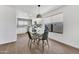 Dining area with a modern table and chairs next to a bright kitchen space at 6108 S Wilson Dr, Chandler, AZ 85249
