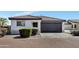 Charming single-story home featuring a dark garage door and low maintenance desert landscaping at 6108 S Wilson Dr, Chandler, AZ 85249