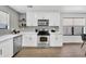 Bright kitchen featuring white cabinets, stainless steel appliances, light countertops and hardwood floors at 6108 S Wilson Dr, Chandler, AZ 85249