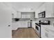 Modern kitchen featuring stainless steel appliances, white cabinetry, and lots of light at 6108 S Wilson Dr, Chandler, AZ 85249