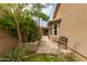 Charming backyard with lush landscaping, patio, and cozy seating area, perfect for relaxing and entertaining at 6128 E Portia St, Mesa, AZ 85215