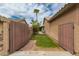 Enclosed backyard area featuring desert landscaping and views of a palm tree at 6128 E Portia St, Mesa, AZ 85215
