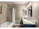 Bathroom featuring a shower and tub combo with a white curtain, vanity and marbled countertop at 6128 E Portia St, Mesa, AZ 85215