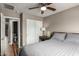 Bedroom with wood flooring, neutral walls, ceiling fan, double closet and ensuite bathroom at 6128 E Portia St, Mesa, AZ 85215