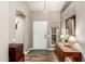 Neutral entryway featuring wood look floors, a white door, and a decorative mirror at 6128 E Portia St, Mesa, AZ 85215
