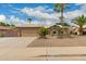 Charming home features a two-car garage, desert landscaping, and a tile roof at 6128 E Portia St, Mesa, AZ 85215