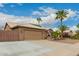 Attractive home with a two-car garage, gated RV parking, and desert landscaping at 6128 E Portia St, Mesa, AZ 85215