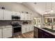Spacious kitchen featuring stainless steel appliances, granite counters, and wood-style flooring at 6128 E Portia St, Mesa, AZ 85215