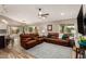 Spacious living room features reclining couches, wood look floors, and recessed lighting at 6128 E Portia St, Mesa, AZ 85215