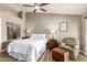 Well-lit bedroom featuring neutral colors, wood-style flooring, and an accent chair at 6128 E Portia St, Mesa, AZ 85215
