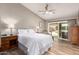 Comfortable bedroom with a ceiling fan and access to a private outdoor pool and patio at 6128 E Portia St, Mesa, AZ 85215