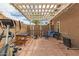 Covered patio transformed into a functional gym, complete with weightlifting equipment, treadmill, and fitness accessories at 6128 E Portia St, Mesa, AZ 85215