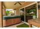 Relaxing patio area featuring a hot tub, sliding glass door and a refreshing ambiance for enjoying outdoor living at 6128 E Portia St, Mesa, AZ 85215