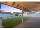 View of a covered backyard patio with artificial grass and brick pavers, perfect for outdoor entertaining at 6228 E Blanche Dr, Scottsdale, AZ 85254