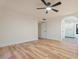 Spacious bedroom with a ceiling fan, ensuite bathroom and light wood flooring at 6228 E Blanche Dr, Scottsdale, AZ 85254