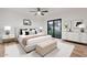 Well-appointed bedroom boasts modern decor, neutral tones, and a sliding door leading to the outdoor space at 6228 E Blanche Dr, Scottsdale, AZ 85254