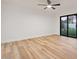 Bedroom with sliding glass door leading to backyard; offers bright, open space with hardwood flooring at 6228 E Blanche Dr, Scottsdale, AZ 85254