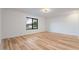 Bedroom with hardwood flooring, a large window, and minimalist decor provides a calming atmosphere at 6228 E Blanche Dr, Scottsdale, AZ 85254