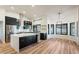 Open-concept kitchen with stainless steel appliances, island, and black cabinetry at 6228 E Blanche Dr, Scottsdale, AZ 85254