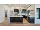 Modern kitchen with stainless steel appliances, dark cabinets, and a large island with white countertop at 6228 E Blanche Dr, Scottsdale, AZ 85254