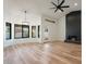 Bright living room with modern fireplace, wood floors, and black-trimmed windows at 6228 E Blanche Dr, Scottsdale, AZ 85254