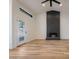 Bright living room with modern fireplace, wood floors, and black-trimmed windows at 6228 E Blanche Dr, Scottsdale, AZ 85254