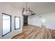 Bright living room featuring light colored wood floors and black framed windows at 6228 E Blanche Dr, Scottsdale, AZ 85254