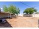 Spacious backyard with mature trees and a covered patio area at 6733 N 49Th Ave, Glendale, AZ 85301
