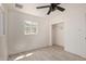 A bedroom with a window, fan, and closet at 6733 N 49Th Ave, Glendale, AZ 85301