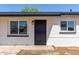 The front of the house features a stylish black steel security door framed by windows at 6733 N 49Th Ave, Glendale, AZ 85301