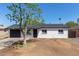 Charming single-story home featuring a well-maintained exterior and a spacious front yard with mature tree at 6733 N 49Th Ave, Glendale, AZ 85301