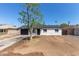 Charming single-story home featuring a well-maintained exterior and a spacious front yard with mature tree at 6733 N 49Th Ave, Glendale, AZ 85301
