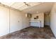 A well-lit garage featuring a workbench, pegboard, and ample storage at 6733 N 49Th Ave, Glendale, AZ 85301